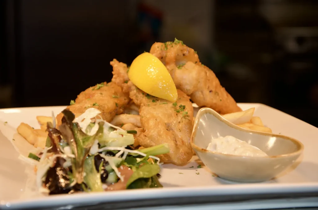 Battered barramundi with chips, salad, lemon and tartare sauce