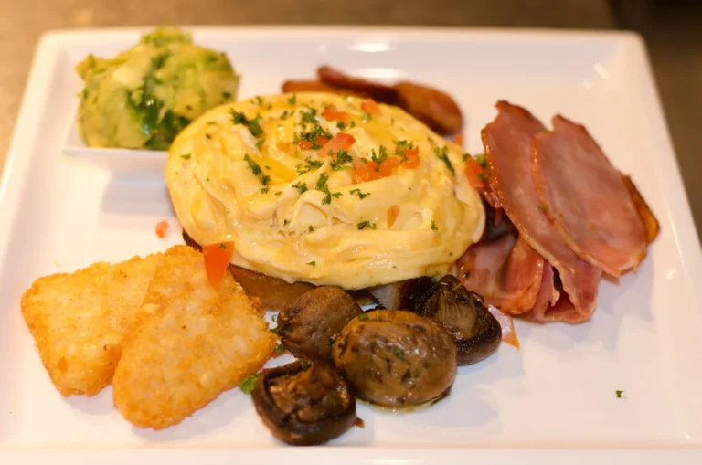 Big breakfast with eggs, bacon, hash brown, mushrooms and avocado