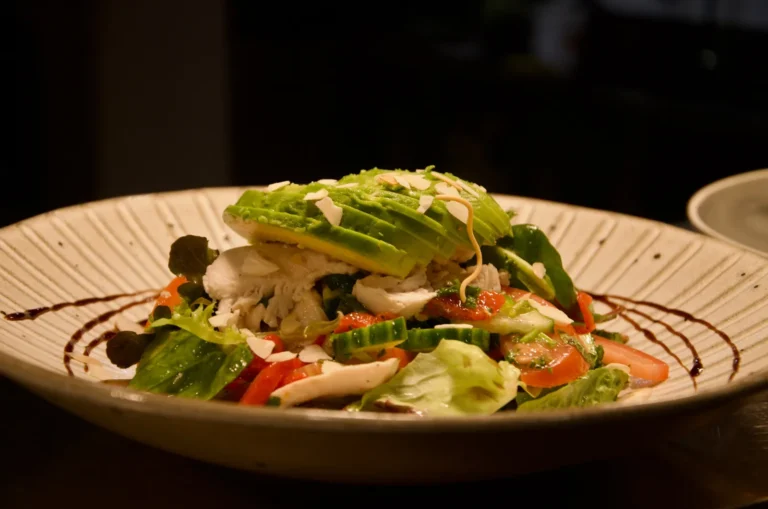 Chicken and avocado salad with roasted capsicum and almonds