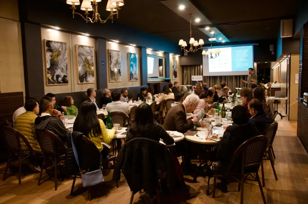 Corporate dinner in La Baguette's dining room with projector, screen and chandeliers