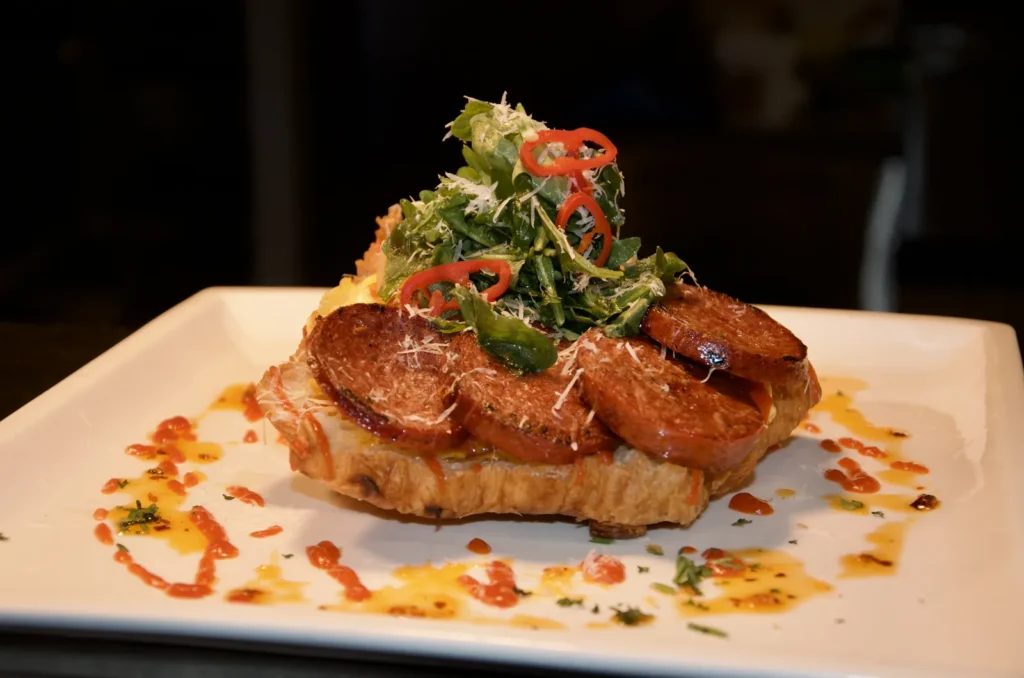 French chilli scrambled croissant with beef sucuk, chilli, rocket and parmesan