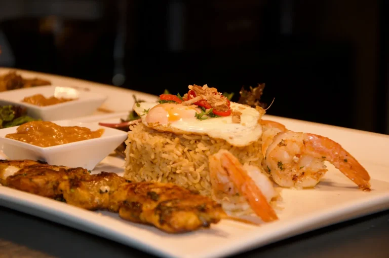 Nasi goreng with fried egg, chicken skewer, garlic prawns and peanut sauce