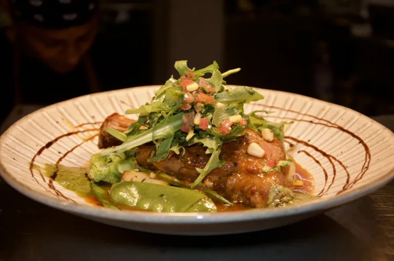 Slow-cooked lamb shank with seasonal vegetables and salsa verde