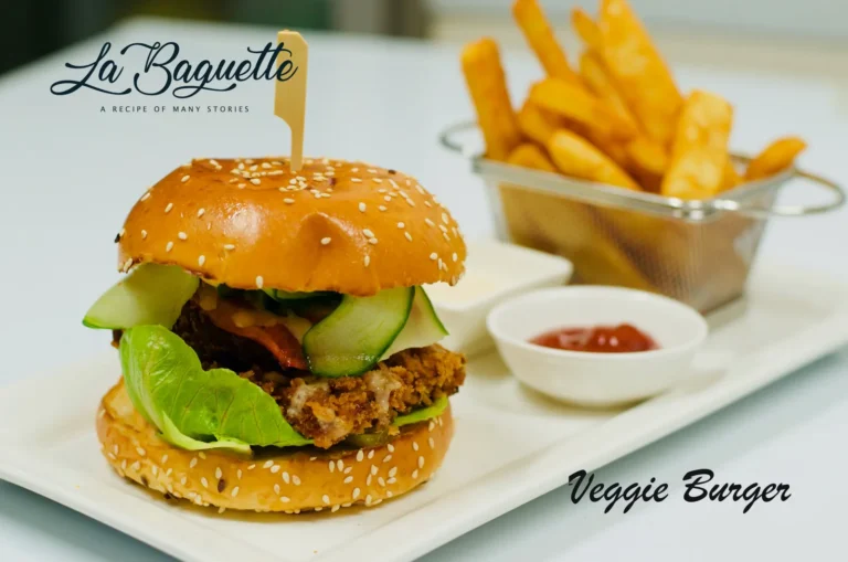 Vegetarian burger with crumbed patty, lettuce and cucumber, served with chips