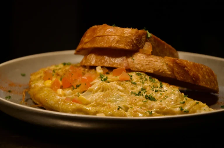 Vegetarian omelette with tomato and corn, served with toasted sourdough